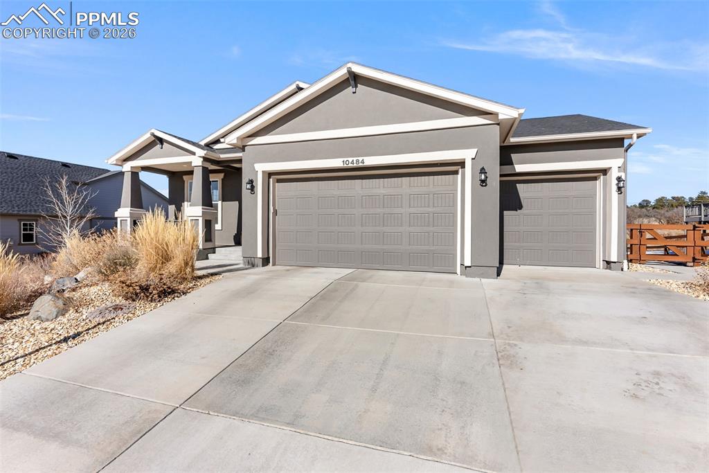 10484 Wrangell Circle Colorado Springs, CO 80924 - Photo 2 of 50 a front view of a house with a yard and garage