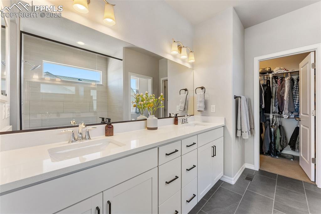 10484 Wrangell Circle Colorado Springs, CO 80924 - Photo 21 of 50 a bathroom with double sink and a mirror