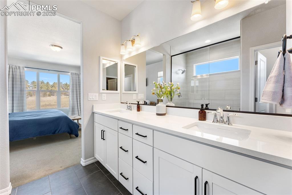 10484 Wrangell Circle Colorado Springs, CO 80924 - Photo 22 of 50 a spacious bathroom with a double vanity sink mirror and double