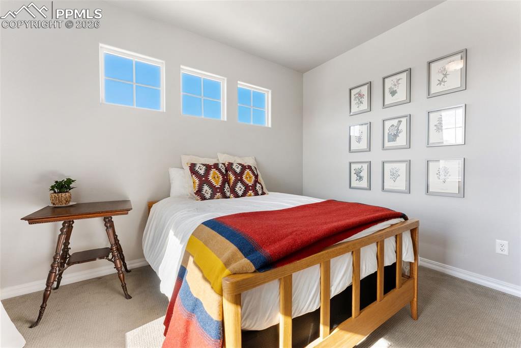10484 Wrangell Circle Colorado Springs, CO 80924 - Photo 25 of 50 a bedroom with a bed and a table in it