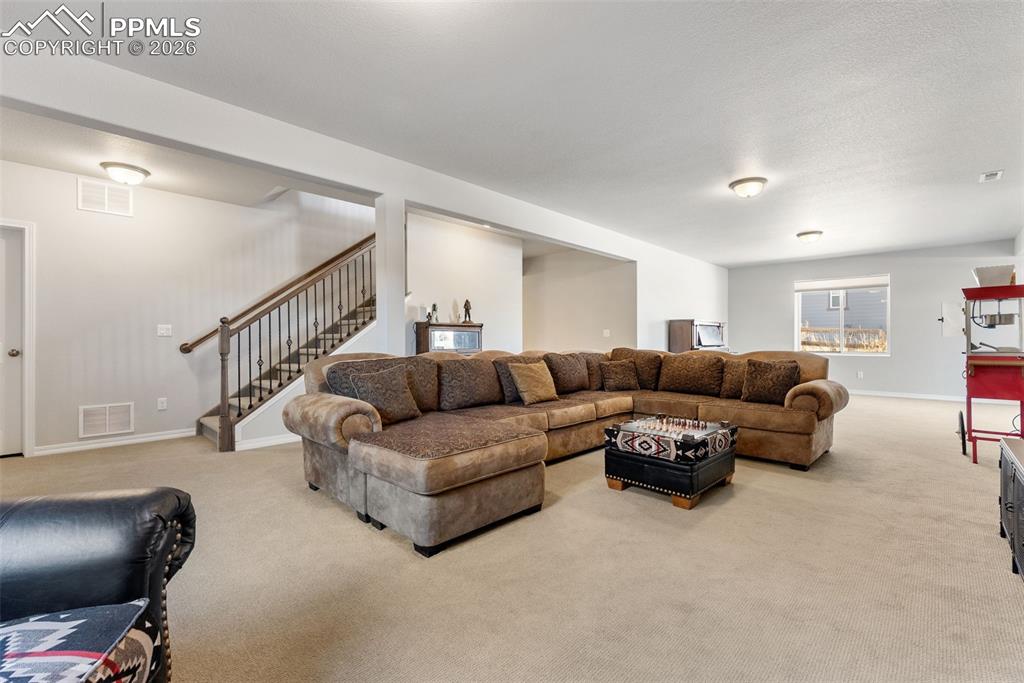 10484 Wrangell Circle Colorado Springs, CO 80924 - Photo 28 of 50 a living room with furniture and a flat screen tv