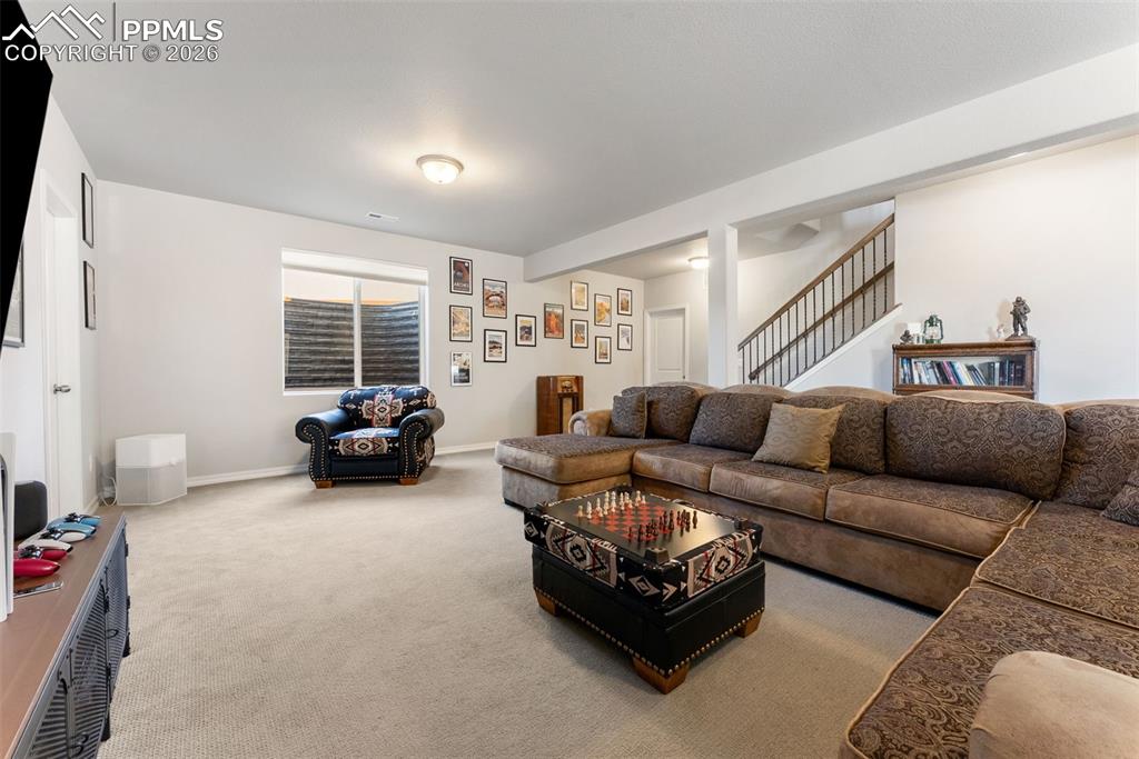10484 Wrangell Circle Colorado Springs, CO 80924 - Photo 29 of 50 a living room with furniture and a flat screen tv