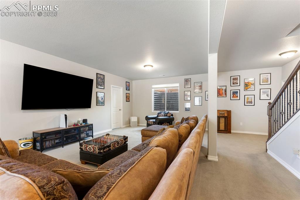 10484 Wrangell Circle Colorado Springs, CO 80924 - Photo 30 of 50 a living room with furniture and a flat screen tv