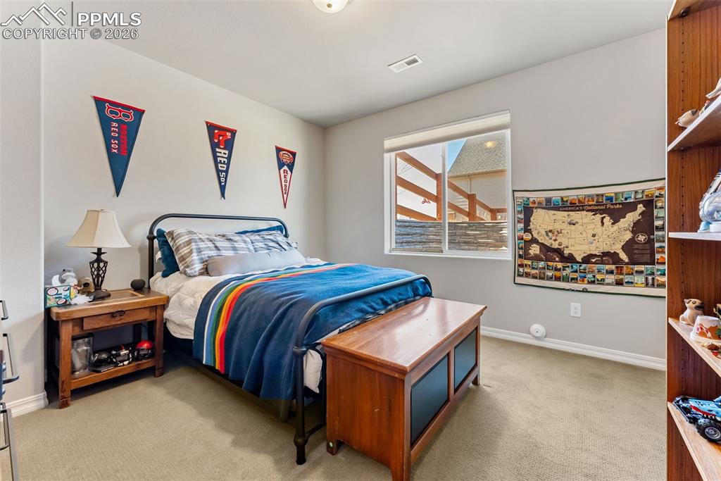 10484 Wrangell Circle Colorado Springs, CO 80924 - Photo 36 of 50 a bedroom with a bed and a painting on the wall