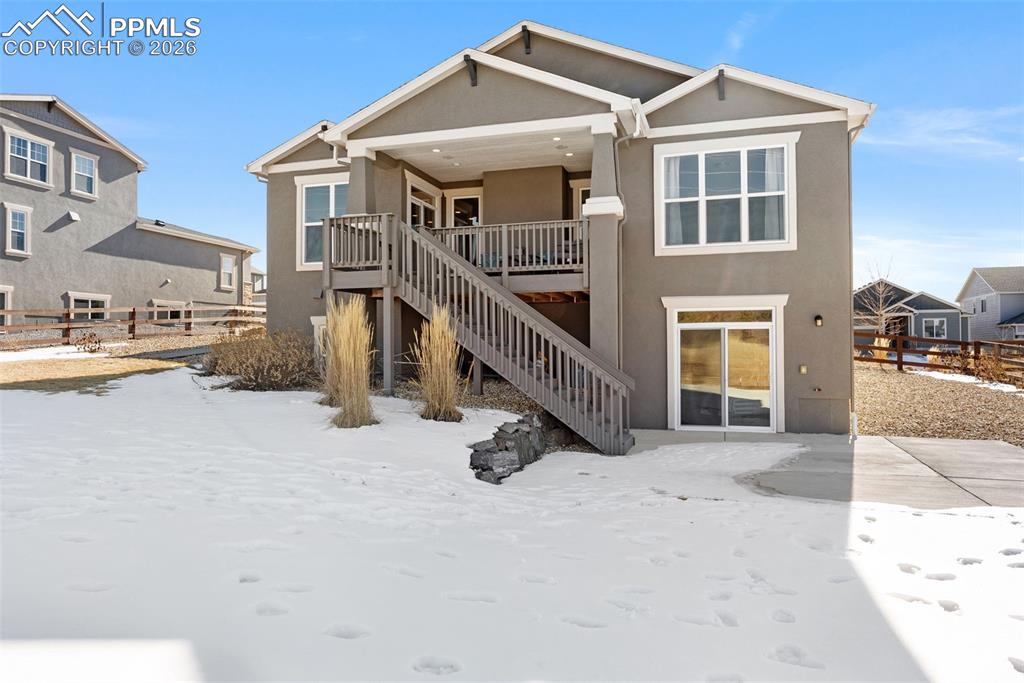 10484 Wrangell Circle Colorado Springs, CO 80924 - Photo 39 of 50 a view of a house with wooden stairs and a car parked front of it