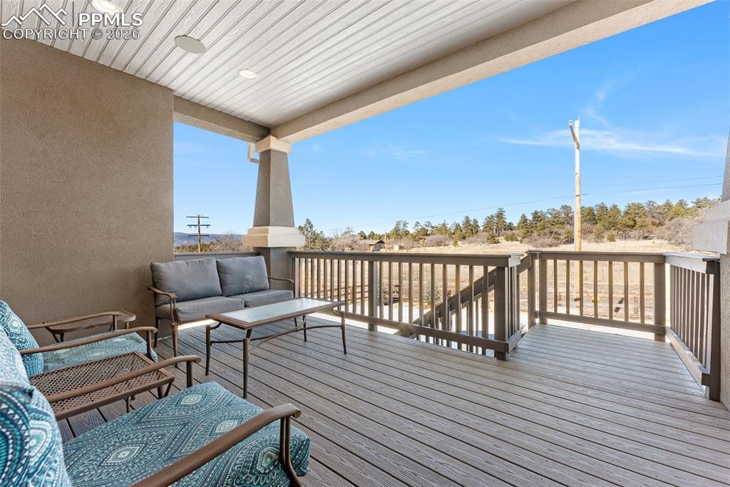 10484 Wrangell Circle Colorado Springs, CO 80924 - Photo 41 of 50 a view of a balcony with wooden floor and outdoor seating