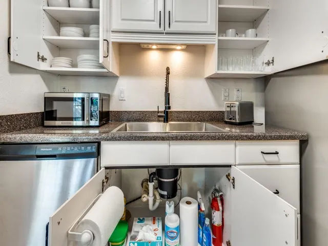 a kitchen with stainless steel appliances granite countertop a sink and a stove