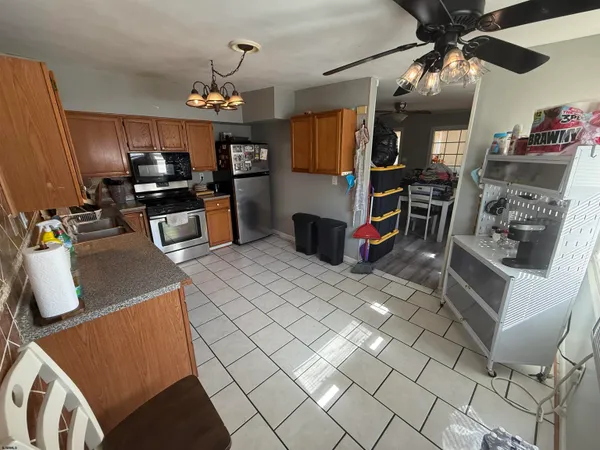a kitchen with stainless steel appliances granite countertop a sink and a refrigerator