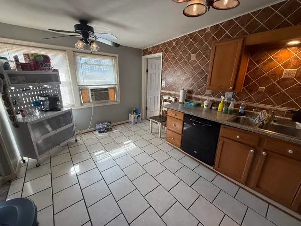 a kitchen with stainless steel appliances a sink stove and cabinets