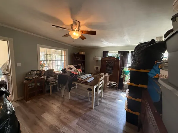 a view of a livingroom with furniture a window and wooden floor