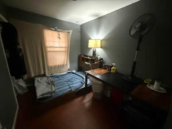 a living room with furniture wooden floor and a flat screen tv