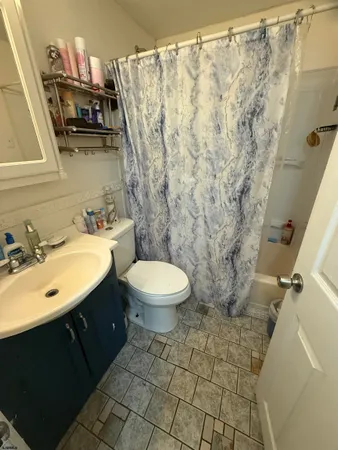 a bathroom with a sink toilet and a mirror