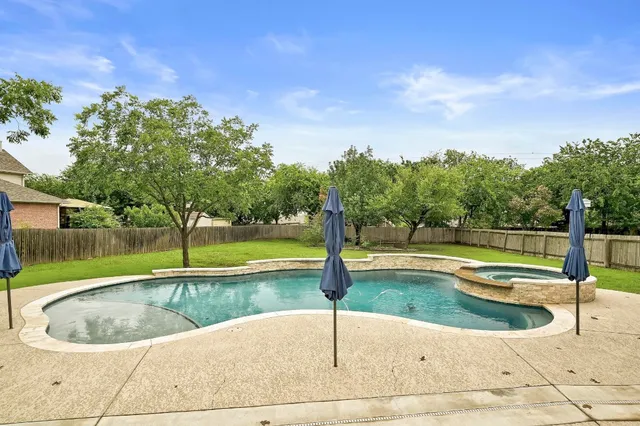 a view of a swimming pool and a yard
