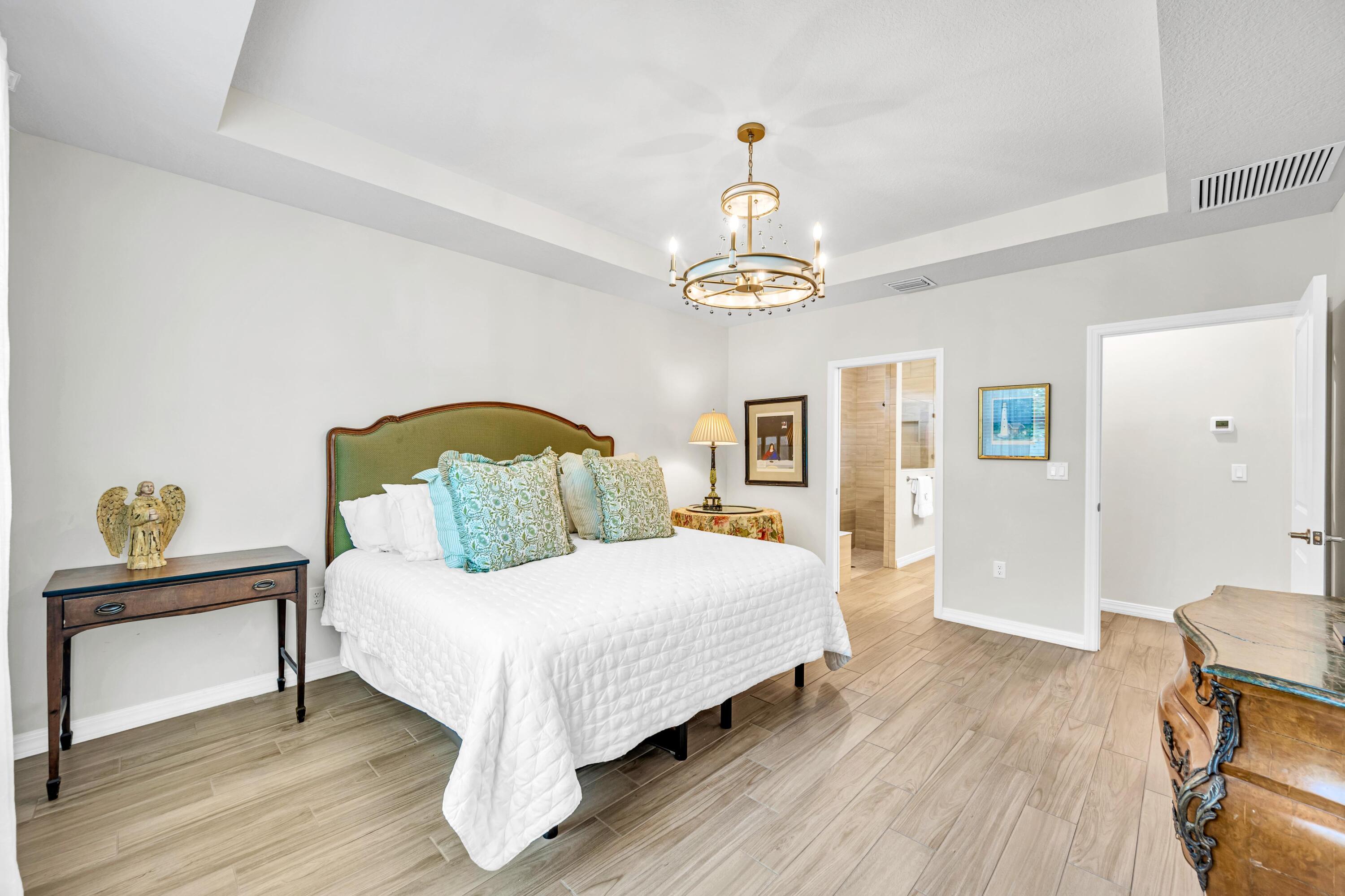 8028 Northwest 78th Street Tamarac, FL 33321 - Photo 16 of 38 a bedroom with a bed and painting on the wall