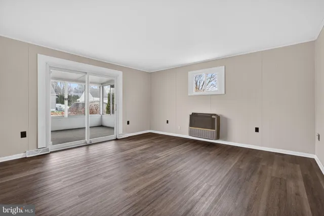 a view of a room with wooden floor and white walls