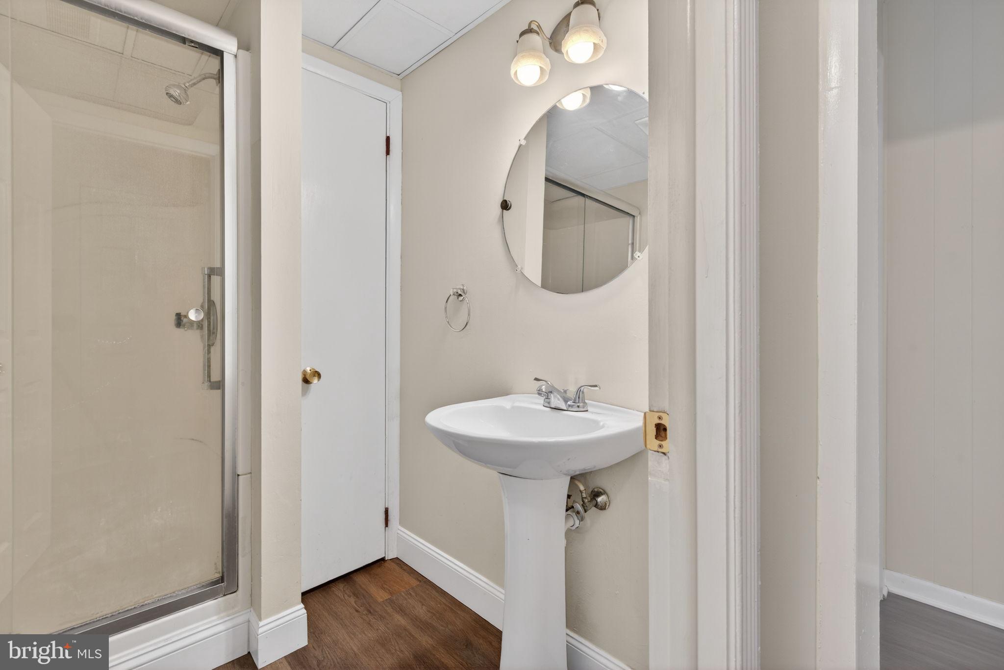 2527 North George Street York, PA 17406 - Photo 14 of 24 a bathroom with a sink a mirror and shower view