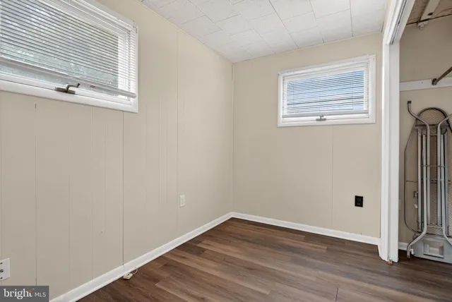 a view of a small space with wooden floor and a window