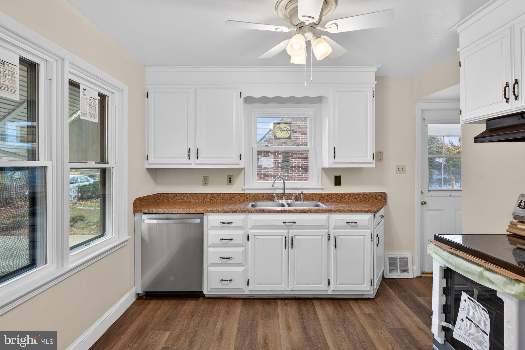 2527 North George Street York, PA 17406 - Photo 2 of 24 a kitchen with granite countertop a sink cabinets and wooden floor