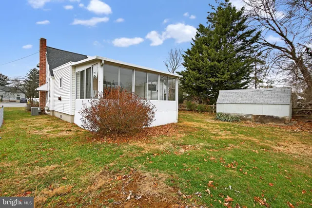a front view of house with yard and trees around