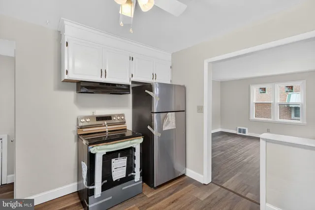 a kitchen with stainless steel appliances a refrigerator stove and microwave