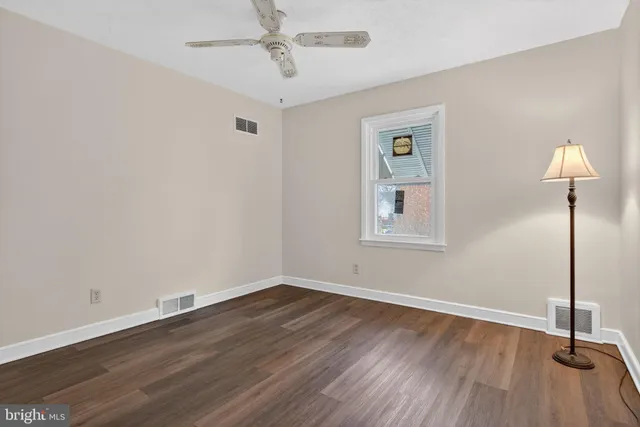a view of a room with wooden floor closet and windows