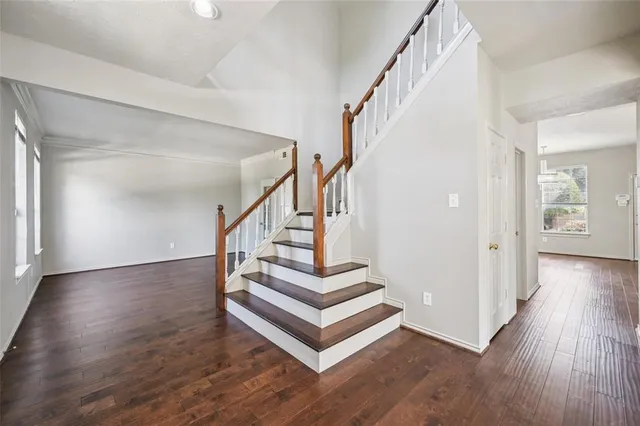a view of entryway and hall with wooden floor