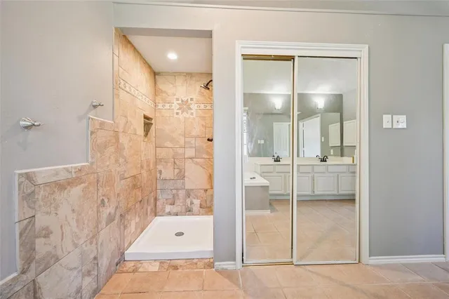 a bathroom with a glass shower door and a glass door shower