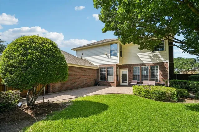 a view of a house with a yard and sitting area