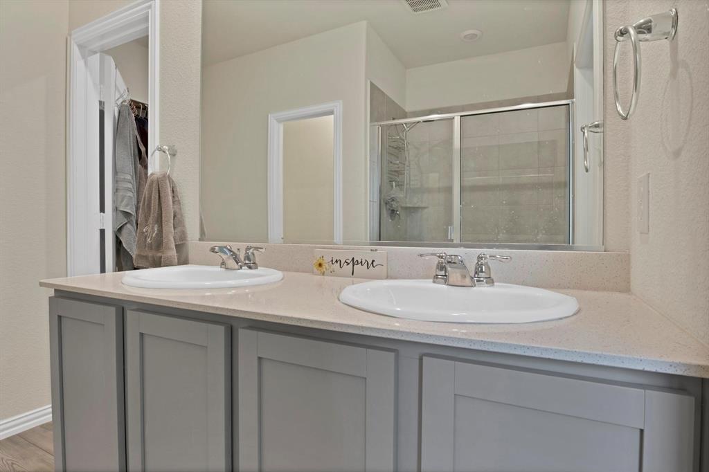 621 Ridgeback Trail Fort Worth, TX 76052 - Photo 12 of 22 Dual vanity with light gray shaker-style cabinetry and a light-toned countertop
