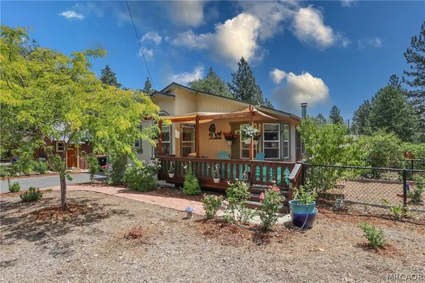 a front view of a house with a yard garage and outdoor seating