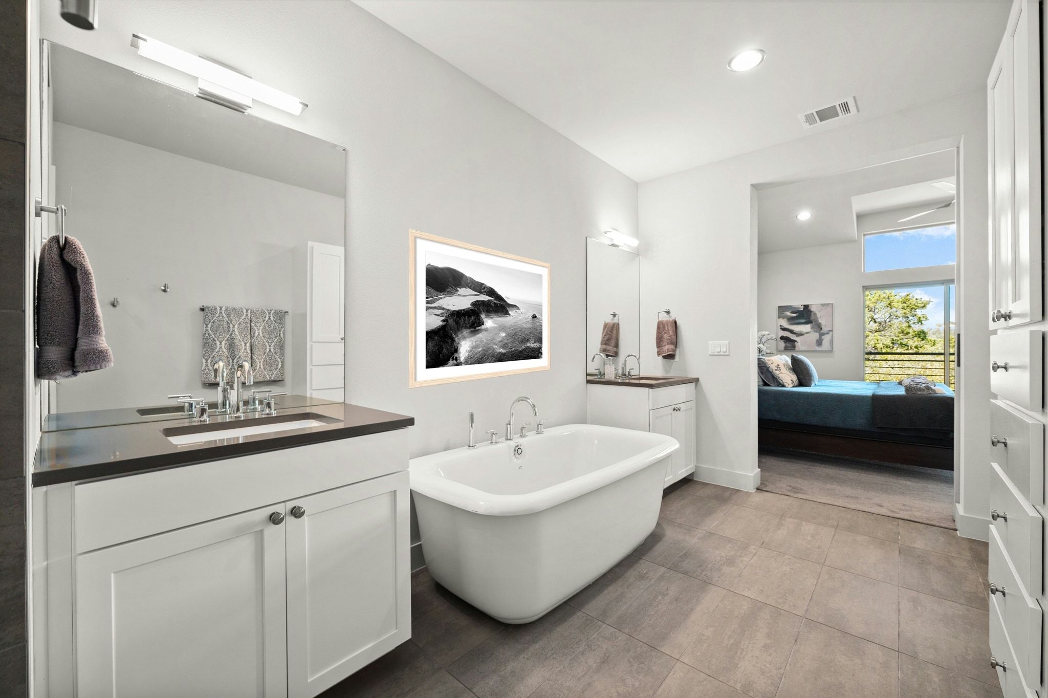 8110 Ranch Road 2222, Unit 92 Austin, TX 78730 - Photo 18 of 40 Spacious bathroom featuring a freestanding soaking tub, dual vanity with undermount sinks, stone countertops, and tile flooring