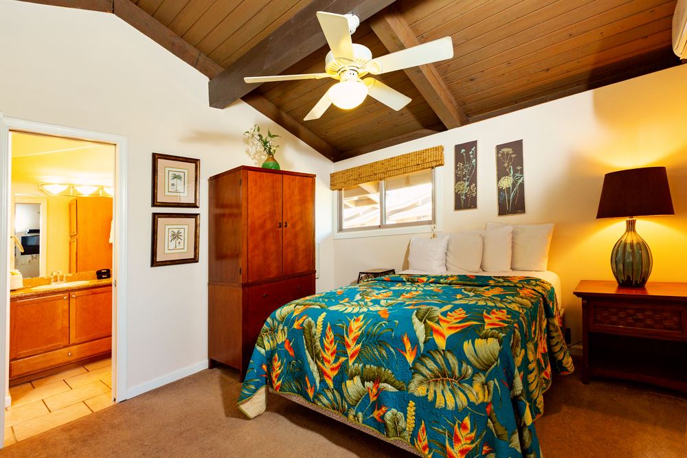 115 North Kihei Road, Unit B1 Kihei, HI 96753 - Photo 12 of 29 a bedroom with a bed and wooden floor