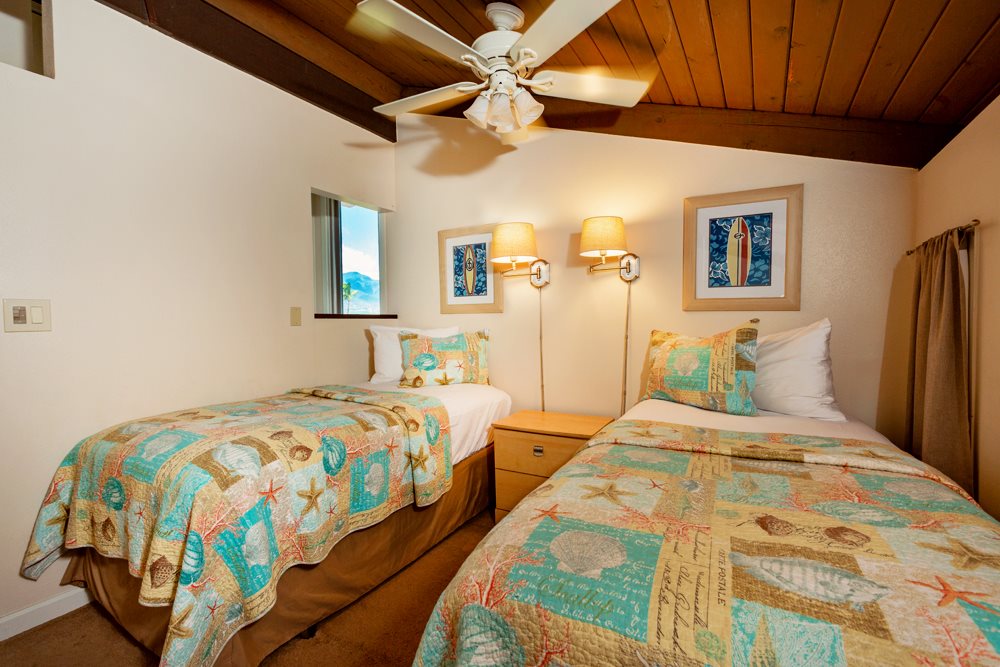 115 North Kihei Road, Unit B1 Kihei, HI 96753 - Photo 14 of 29 a bedroom with double bed and a chandelier
