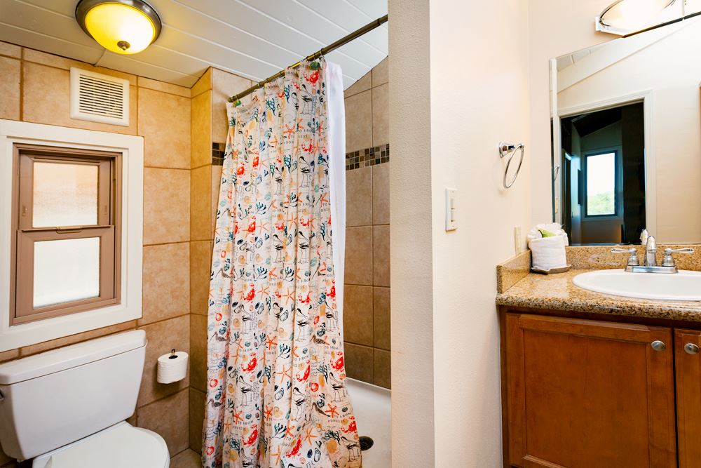 115 North Kihei Road, Unit B1 Kihei, HI 96753 - Photo 15 of 29 a bathroom with a granite countertop sink a toilet and shower curtain