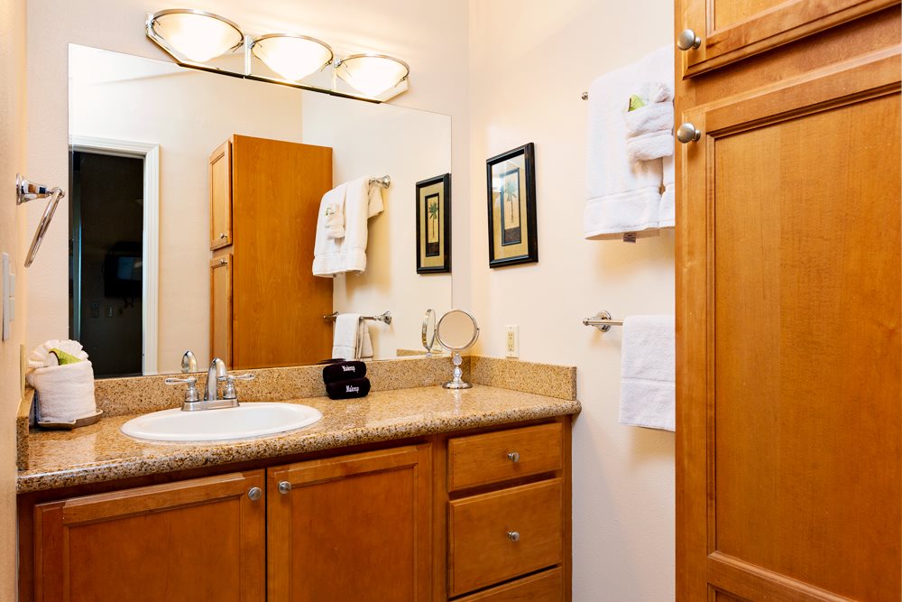 115 North Kihei Road, Unit B1 Kihei, HI 96753 - Photo 16 of 29 a bathroom with a granite countertop sink and a mirror
