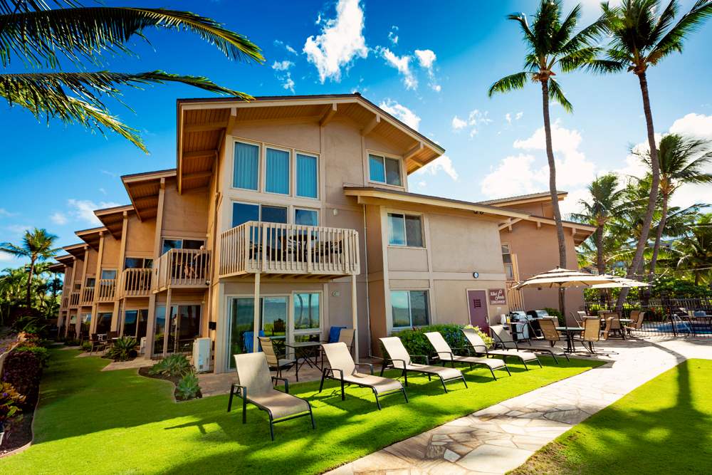 115 North Kihei Road, Unit B1 Kihei, HI 96753 - Photo 26 of 29 a view of a house with swimming pool lawn chairs and a fire pit