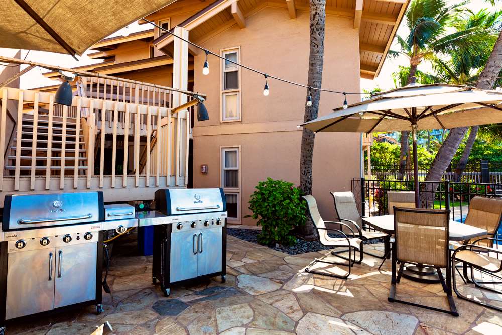 115 North Kihei Road, Unit B1 Kihei, HI 96753 - Photo 27 of 29 a view of a patio with a table and chairs under an umbrella