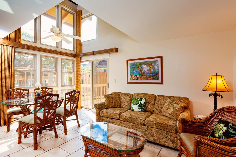 115 North Kihei Road, Unit B1 Kihei, HI 96753 - Photo 6 of 29 a living room with furniture a flat screen tv and a large window