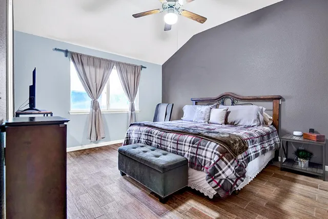 a bedroom with a large bed and a chandelier