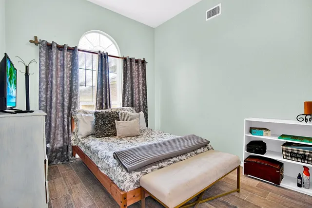 a bedroom with a bed and a large window