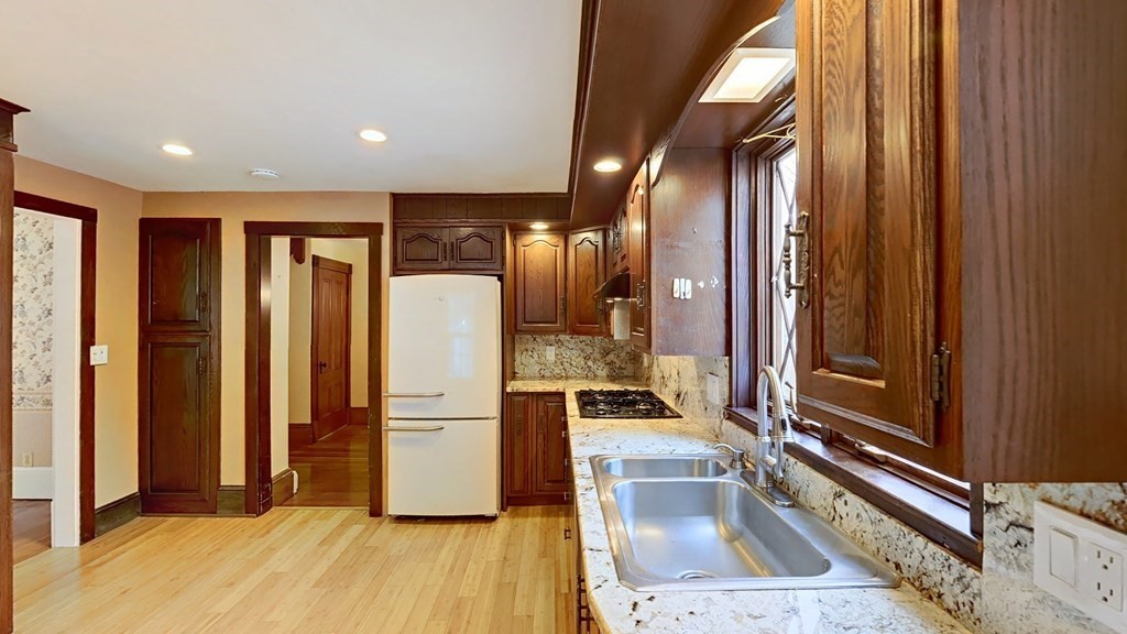 a kitchen with refrigerator and sink