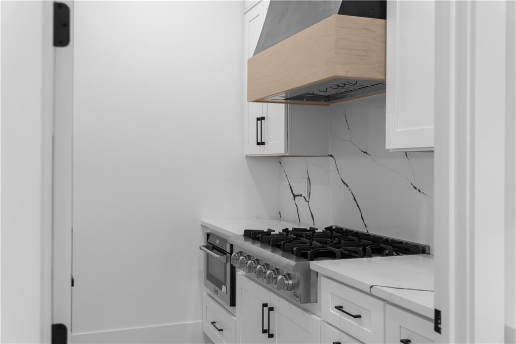 405 Thunder Road Buford, GA 30518 - Photo 40 of 104 a white stove top oven sitting inside of a kitchen