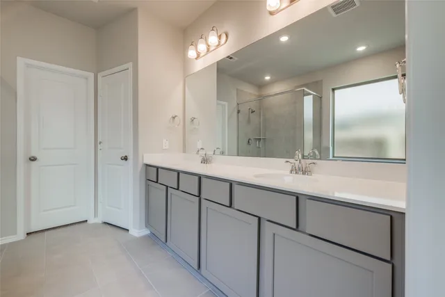 a bathroom with a double vanity sink and a mirror