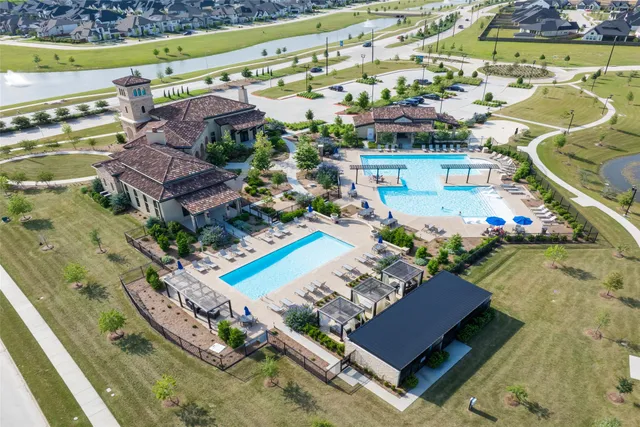 an aerial view of a house with a garden and lake view