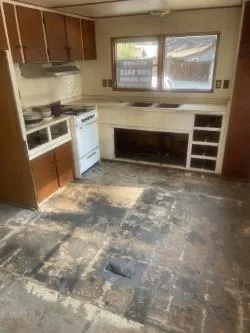 a kitchen with granite countertop a stove and a sink