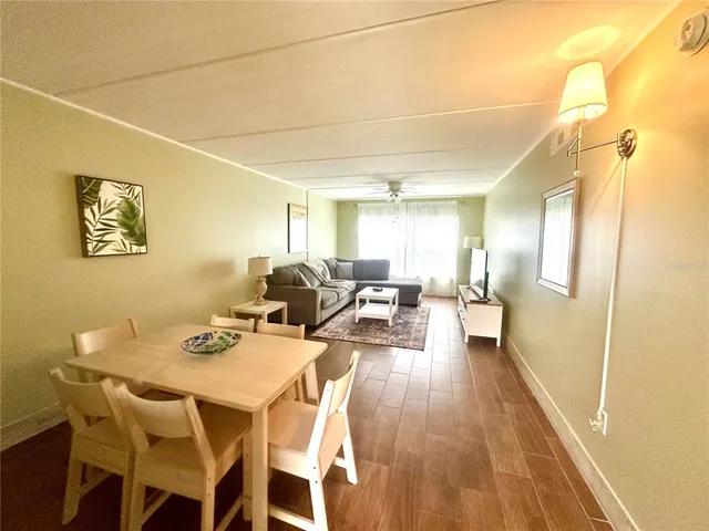 a view of a dining room with furniture and a chandelier