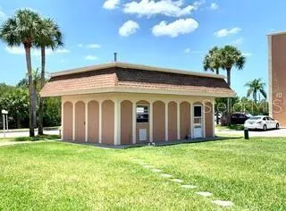 a view of a house with a yard and potted plants