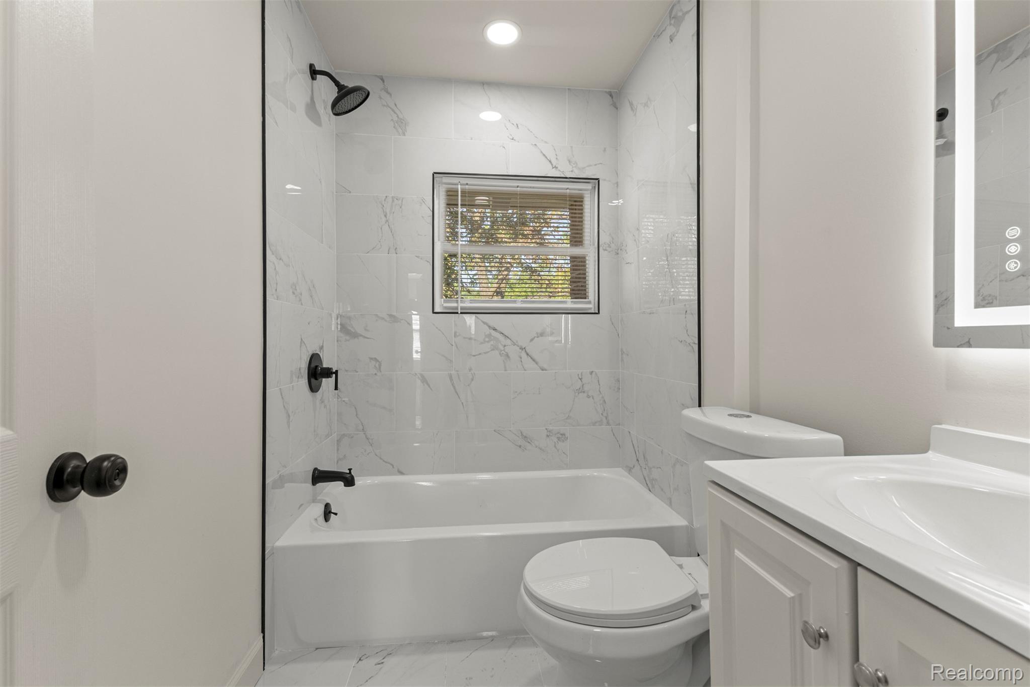 19320 Telegraph Road Detroit, MI 48219 - Photo 11 of 27 Full bath featuring vanity, shower / bathtub combination, and light marble finish floors