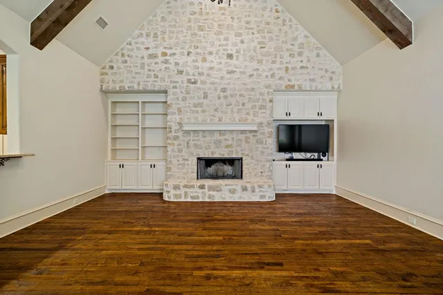 a view of empty room with a fireplace