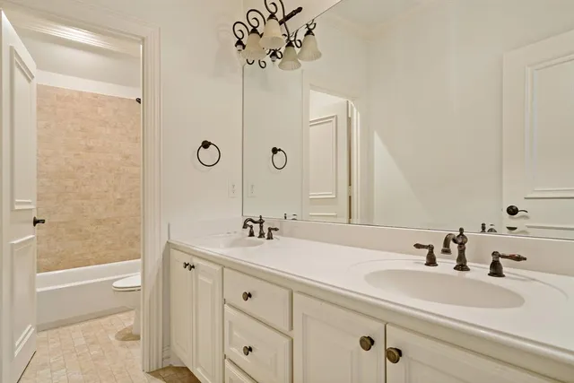 a bathroom with a sink double vanity and a mirror